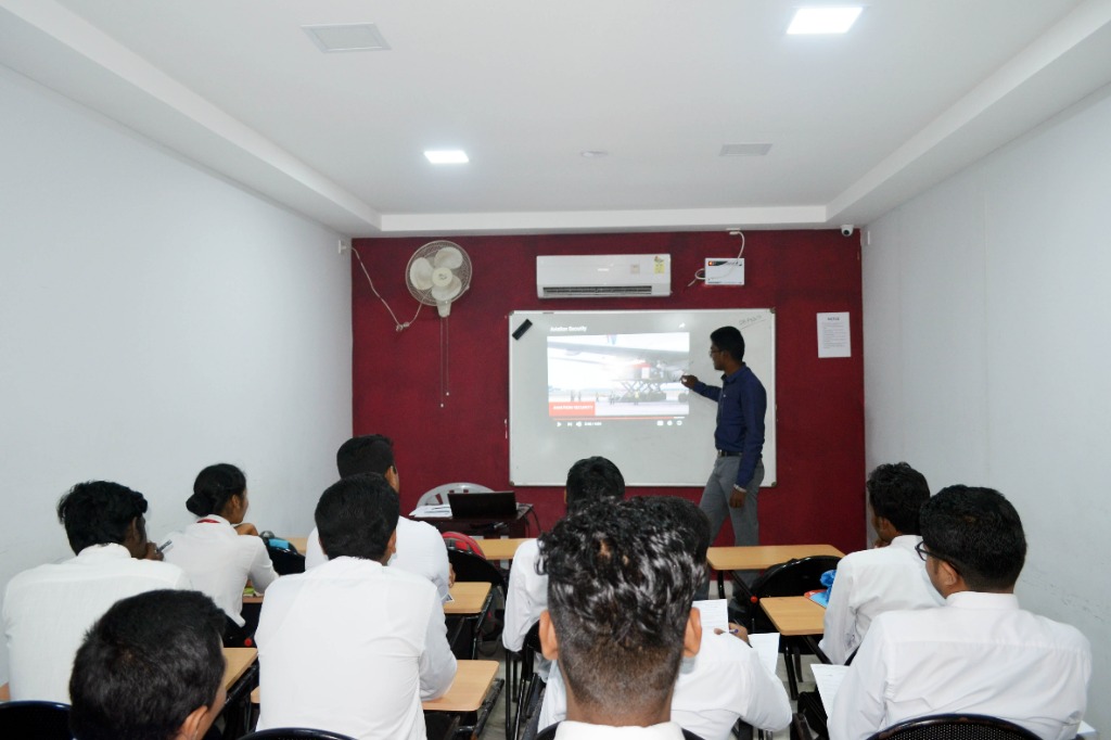 Instructor conducting projector-based aviation lecture for diploma students at Fly Air Aviation Academy